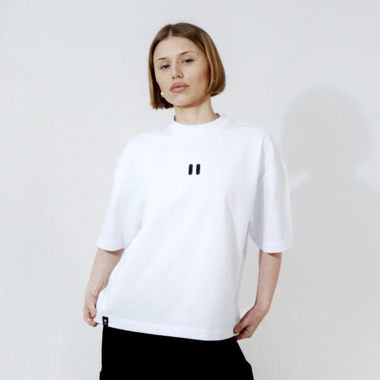 Person wearing a white t-shirt with the roph black logo on a plain background